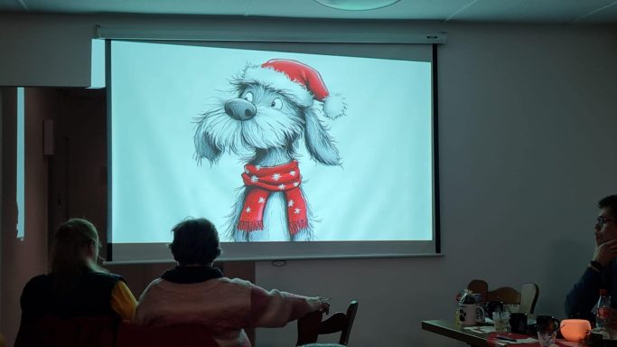 Ein gezeichnetes Tier im Weihnachtsoutfit mit roter Mütze und Hose.